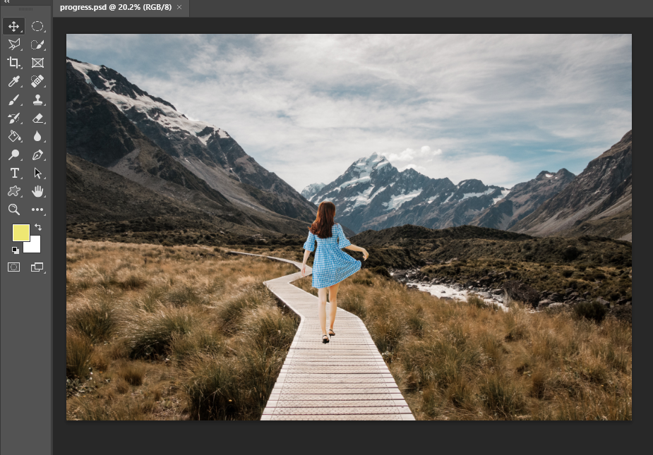 The girl has been cut out of the one photo and added to the boardwalk path in the mountains